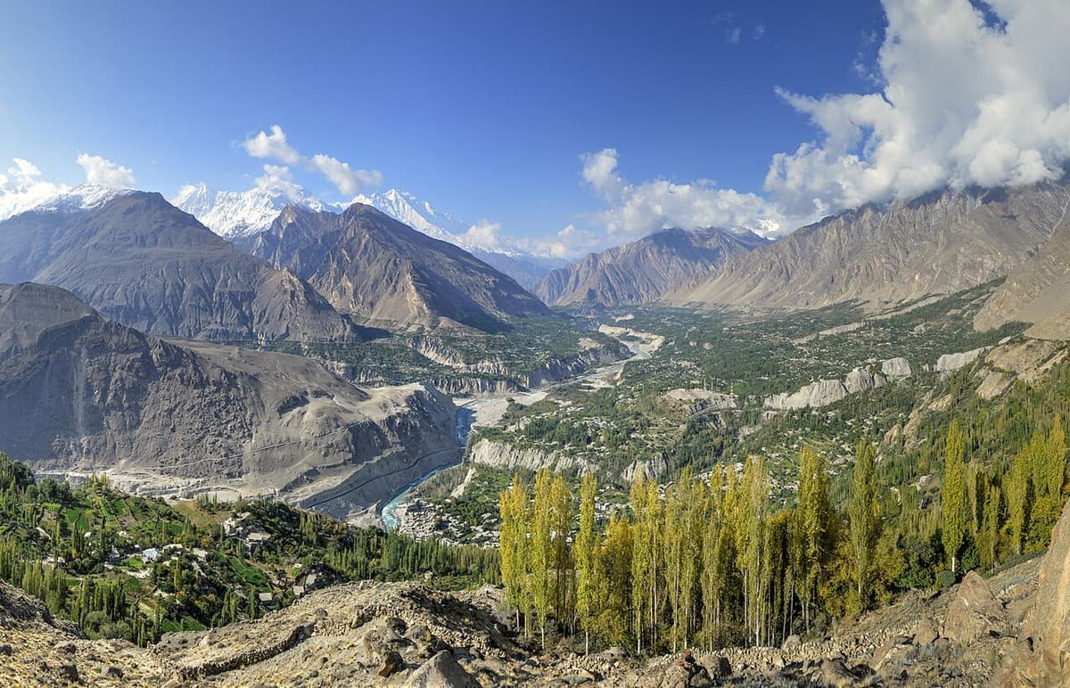 The green Hunza valley seen from the ridge at Eagle’s Nest, with poplars in front and snowy peaks along the skyline